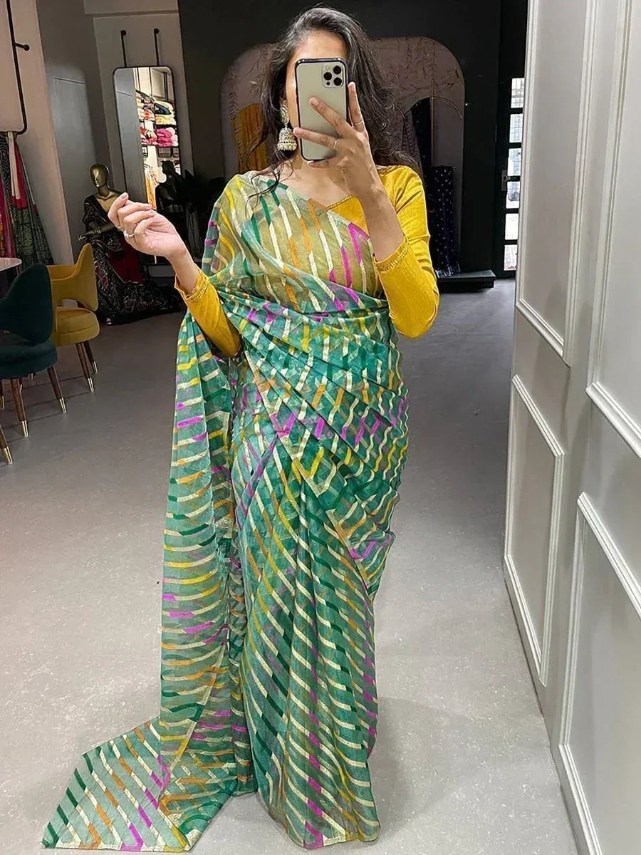 Woman wearing vibrant green and yellow striped saree with matching blouse, perfect for ethnic occasions