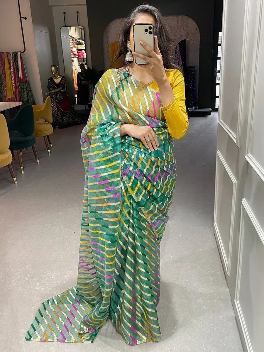 Woman wearing vibrant green striped saree with yellow blouse, perfect for Indian ethnic occasions