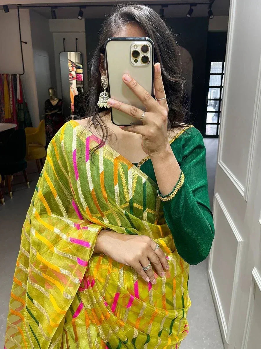 Vibrant green and yellow saree with pink stripes, paired with a velvet blouse, perfect for ethnic occasions.
