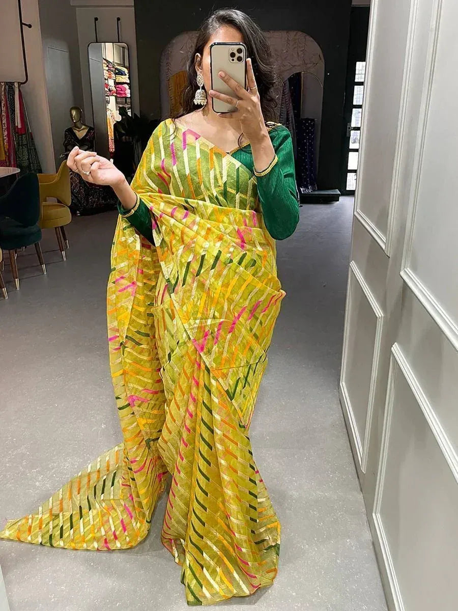 Yellow and green printed saree with ethnic design, styled with green blouse for festive occasions