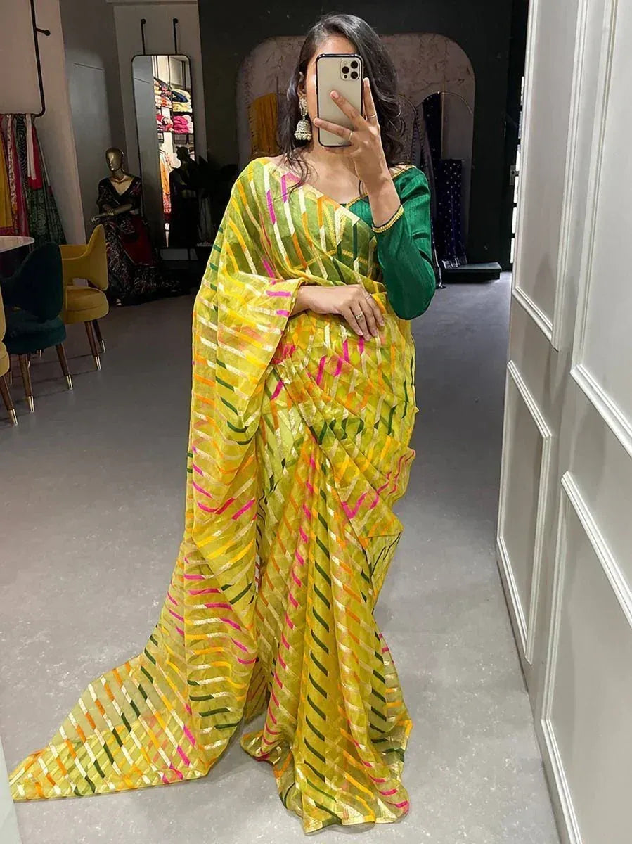 Vibrant yellow saree with pink, green, and orange stripes paired with green blouse, perfect for festive occasions.