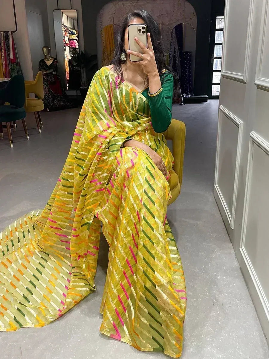 Vibrant yellow saree with green and pink stripes, paired with a green blouse, perfect for ethnic occasions.