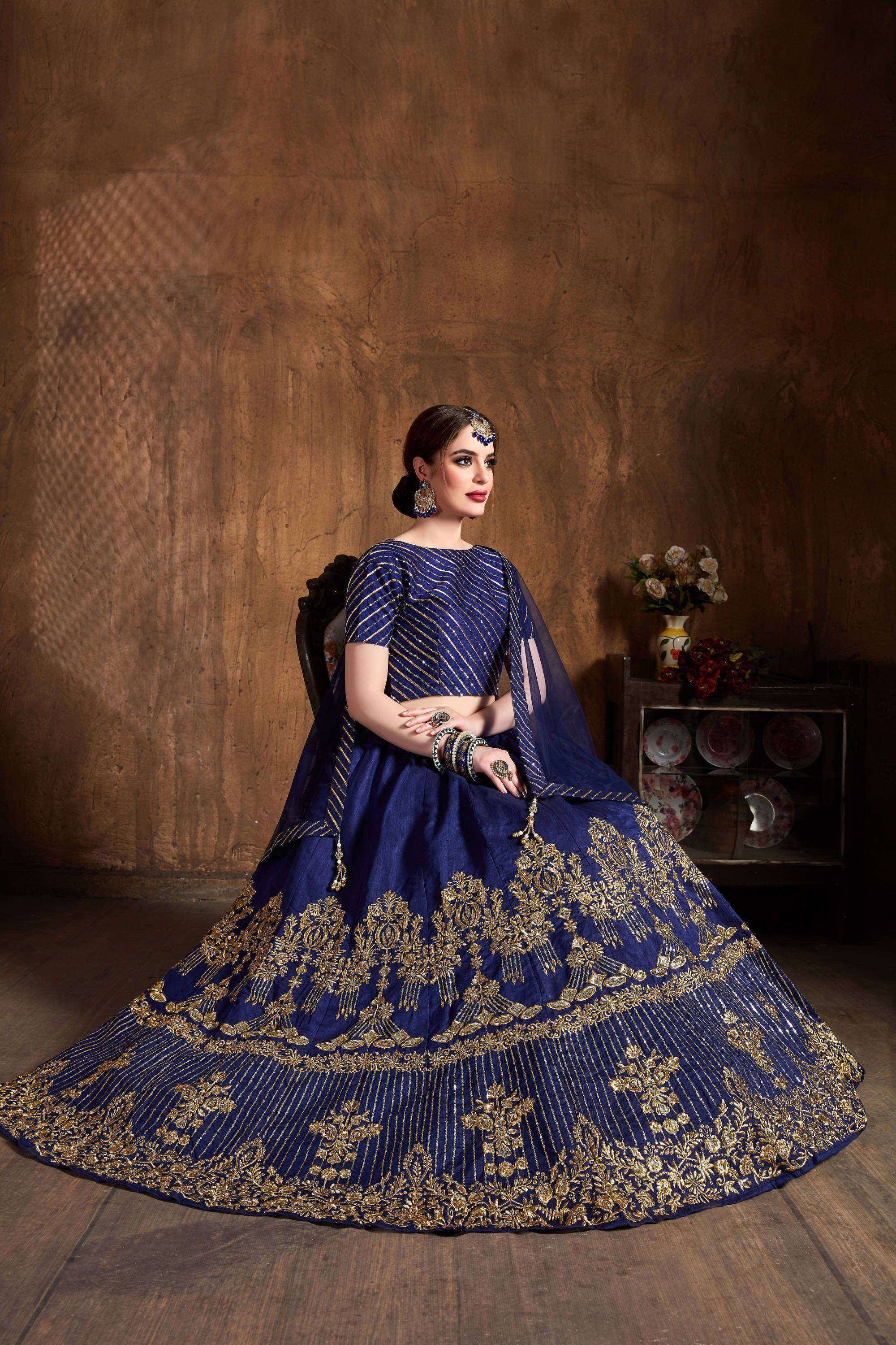 Royal blue lehenga choli with gold embroidery, perfect for Indian weddings and festive occasions.