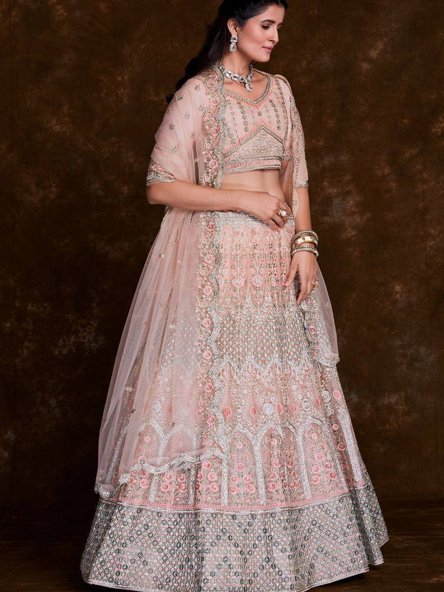 Pink embroidered lehenga choli with floral motifs and sheer dupatta, perfect for Indian weddings and festive occasions.