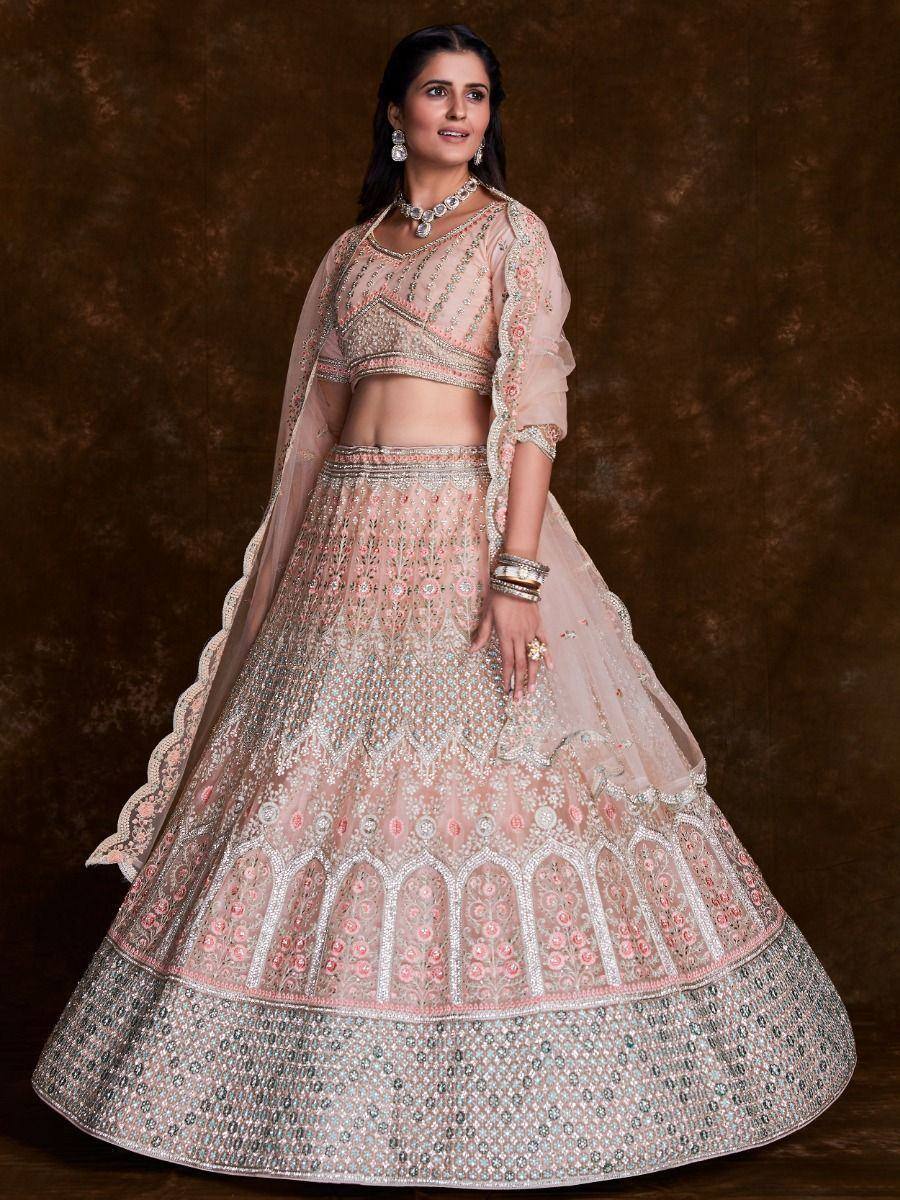 Elegant pink designer lehenga choli with intricate embroidery and sequin work, perfect for Indian weddings