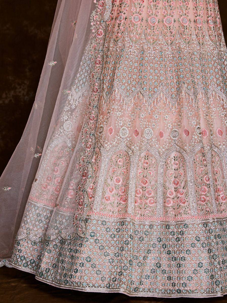 Pink floral embroidered lehenga with intricate silver and blue detailing, perfect for Indian weddings and festive occasions.