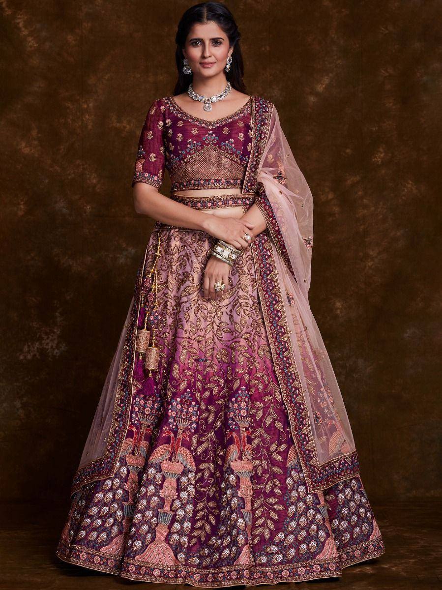Elegant maroon and pink embroidered lehenga choli with peacock motifs, perfect for Indian weddings and festive occasions.