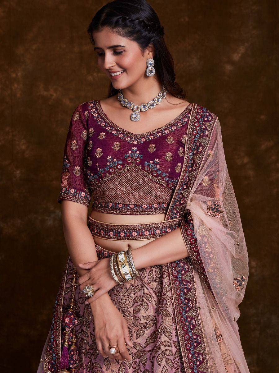 Elegant maroon and pink embroidered lehenga choli with floral motifs and sheer dupatta, perfect for Indian weddings.