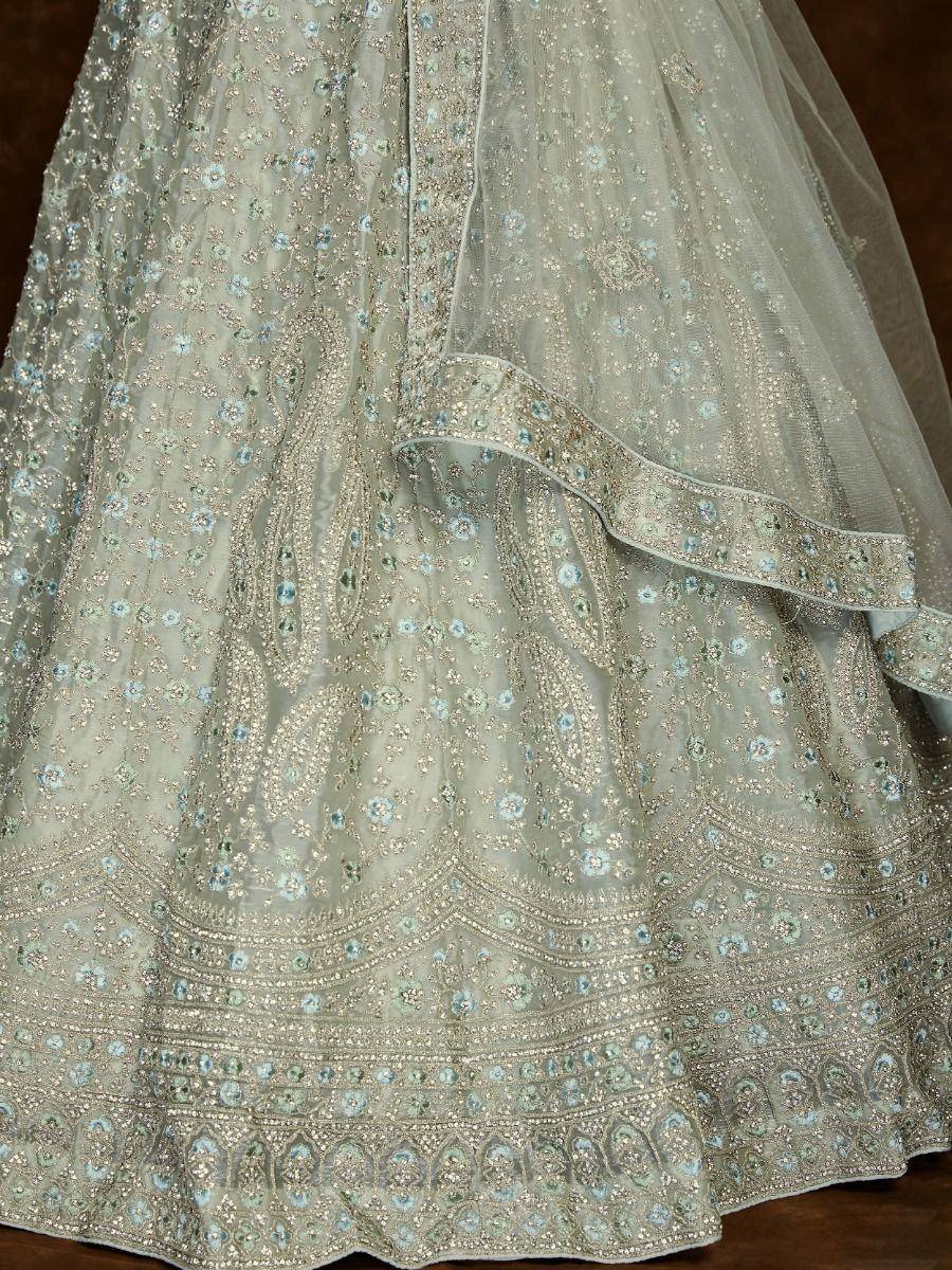 Light green embroidered lehenga with floral motifs and silver zari work, perfect for Indian weddings