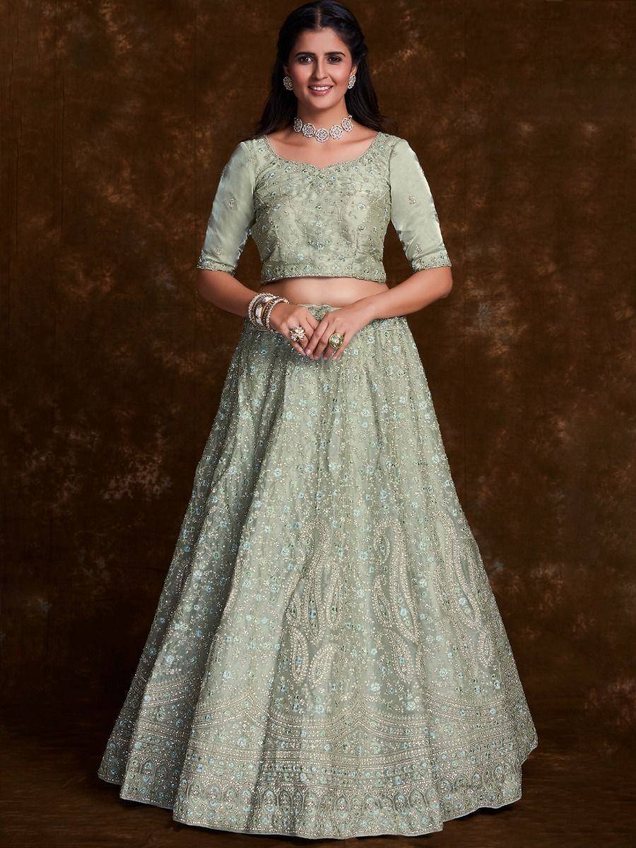 Mint green embroidered lehenga choli with floral motifs and sequin work, perfect for Indian weddings or festive occasions.