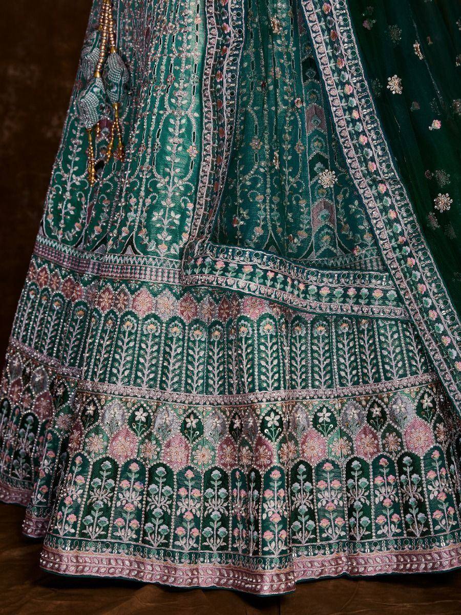 Emerald green designer lehenga with intricate floral embroidery and embellished borders, perfect for Indian ethnic wear.