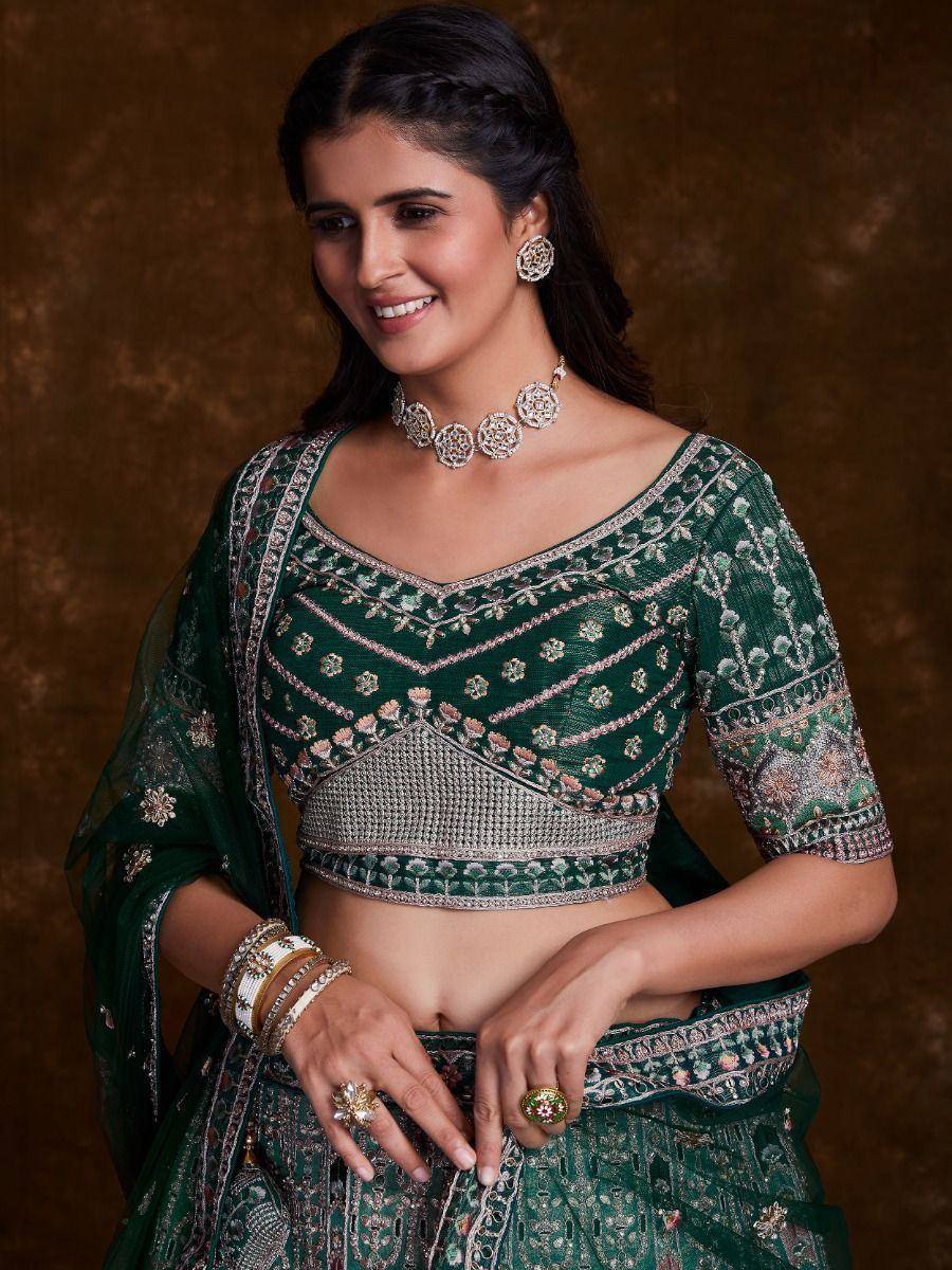Elegant green embroidered lehenga choli with matching jewelry for Indian ethnic wear