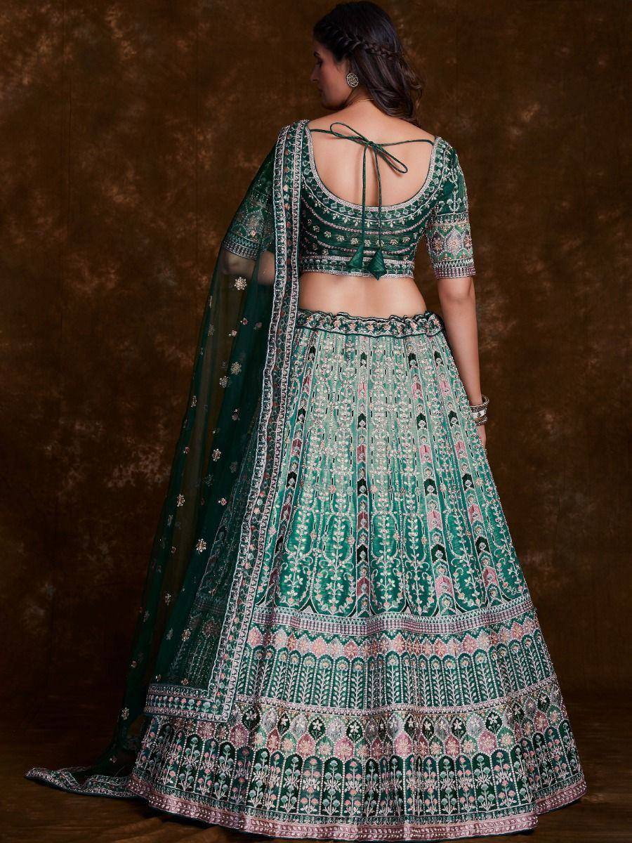 Emerald green designer lehenga choli with intricate embroidery and back tie blouse, perfect for Indian weddings