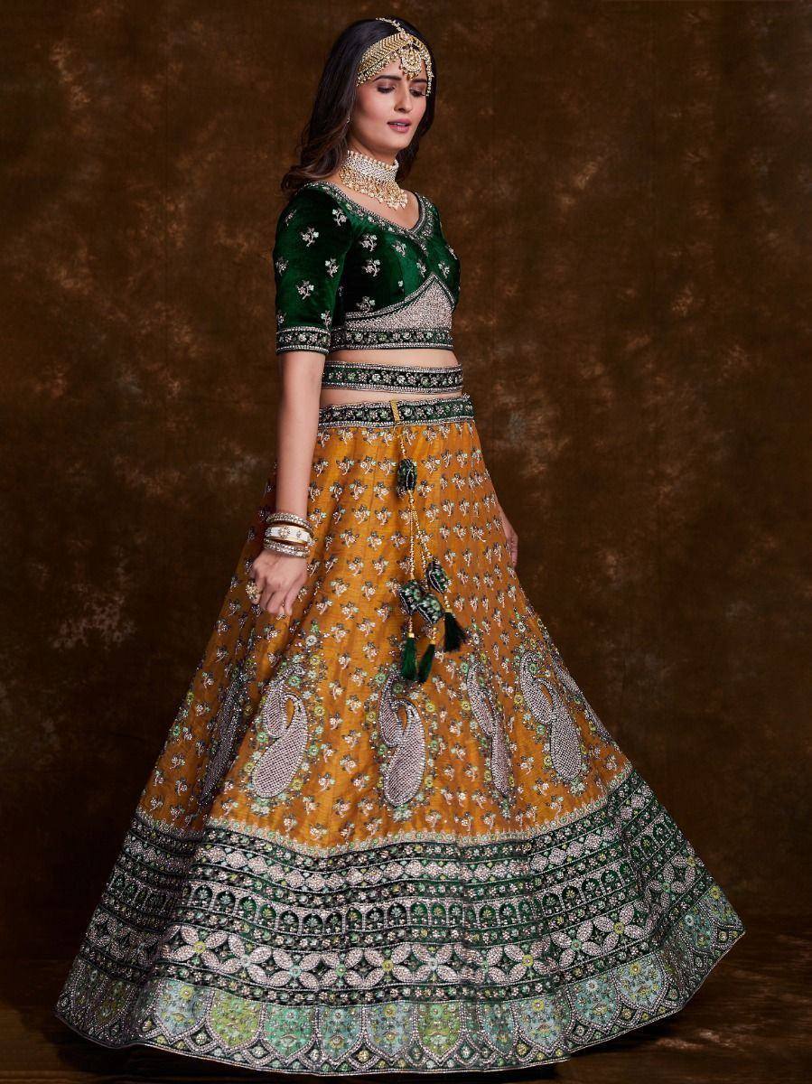 Green and mustard designer lehenga choli with intricate embroidery and tassels, perfect for Indian ethnic wear