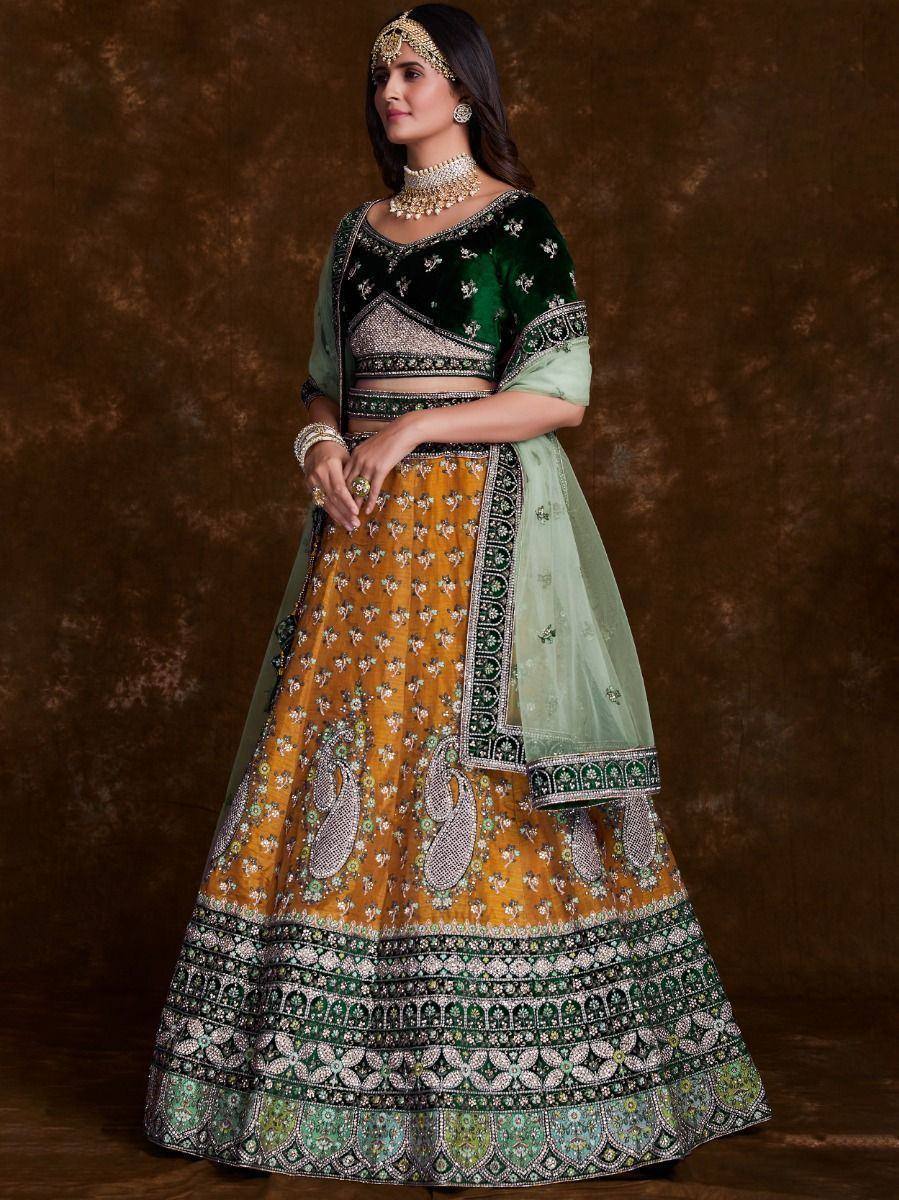Green and mustard designer lehenga choli with intricate embroidery and matching dupatta for Indian ethnic wear