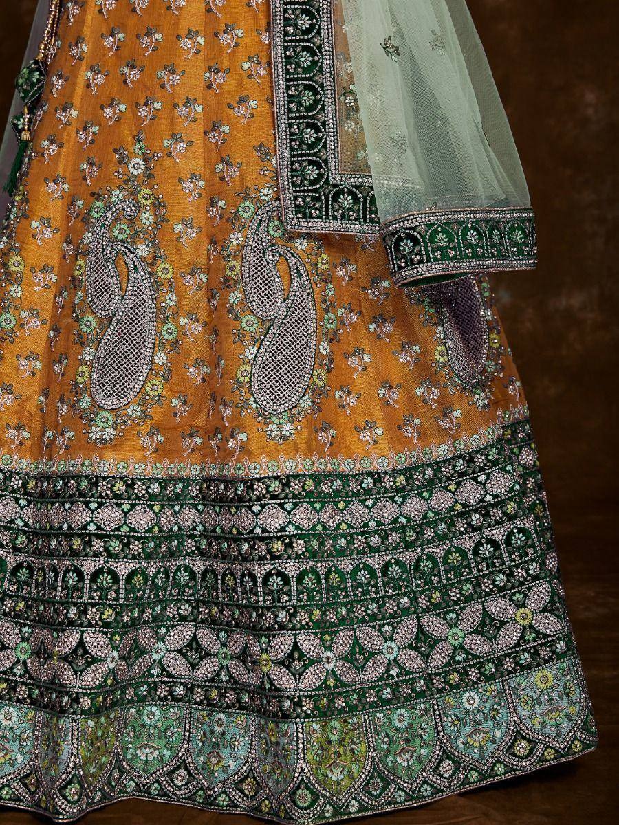 Mustard and green designer lehenga with intricate floral and paisley embroidery, perfect for Indian ethnic wear.
