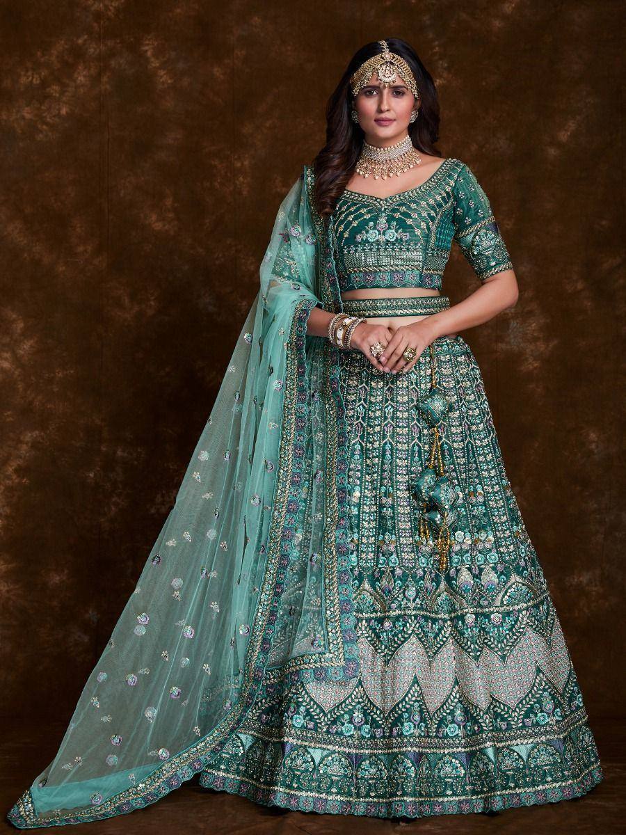 Emerald green designer lehenga choli with heavy embroidery and matching dupatta, perfect for Indian weddings