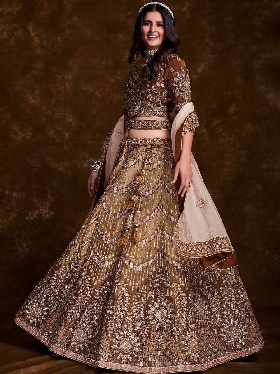 Elegant brown designer lehenga choli with intricate gold embroidery and matching dupatta for Indian weddings