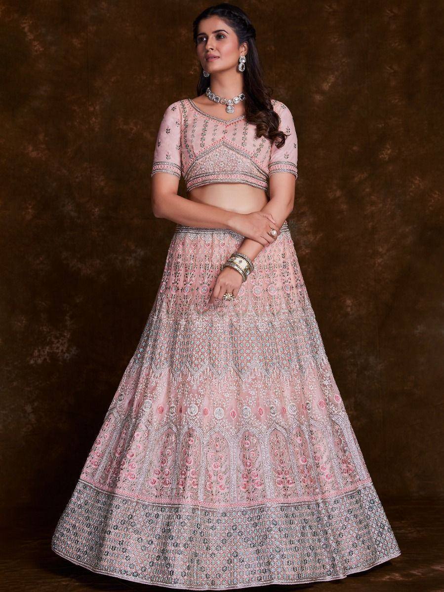 Pink embroidered lehenga choli with intricate floral patterns, perfect for Indian weddings and festive occasions.