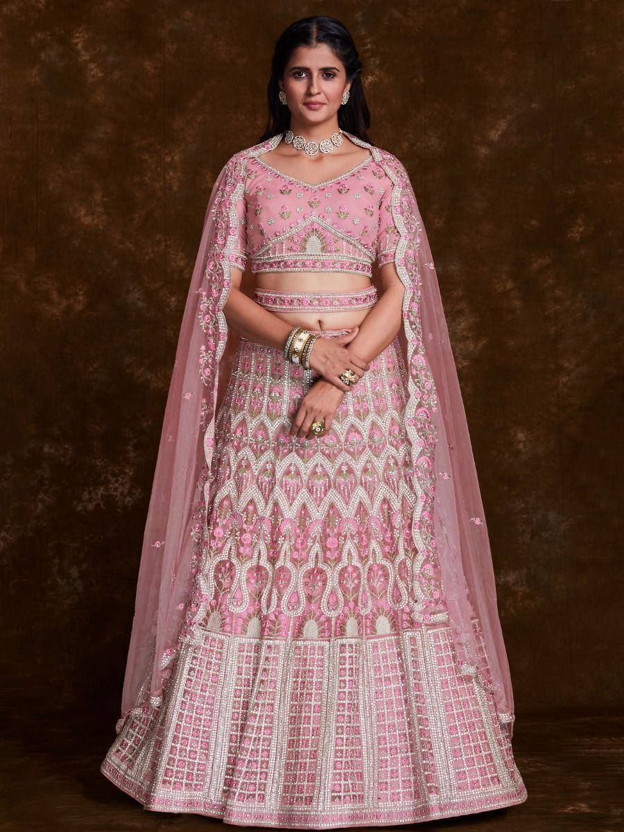 Pink designer lehenga choli with intricate embroidery and matching dupatta, perfect for weddings and festive occasions.