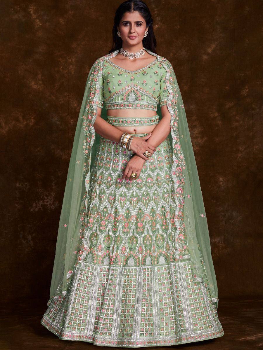 Mint green embroidered lehenga choli with floral motifs and sheer dupatta, perfect for Indian ethnic occasions.