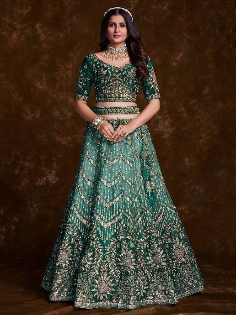 Emerald green designer lehenga choli with gold embroidery, perfect for Indian weddings and festive occasions.