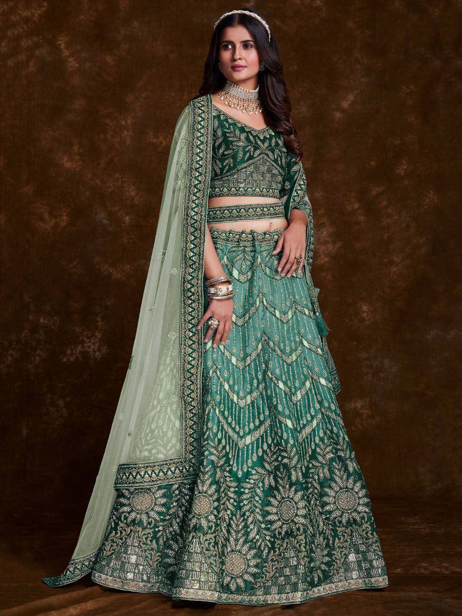 Emerald green designer lehenga choli with intricate gold embroidery and sheer dupatta for weddings