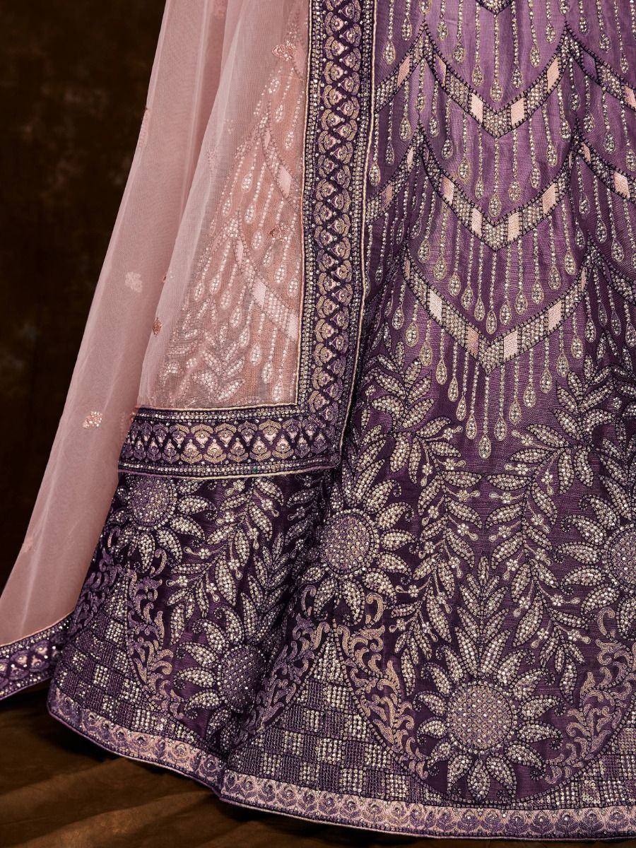Purple designer lehenga with intricate gold embroidery and sheer pink dupatta, perfect for Indian ethnic wear.