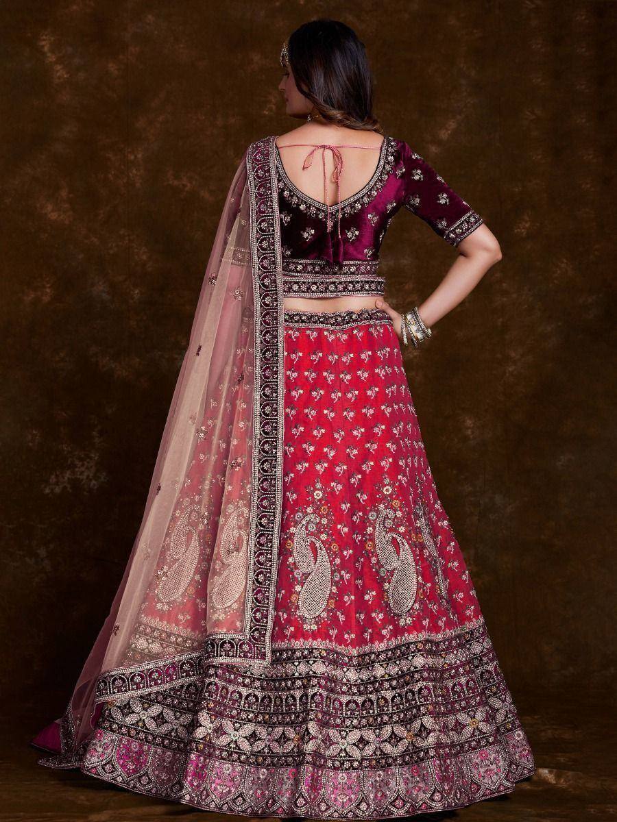 Red and maroon embroidered lehenga choli with sheer dupatta, perfect for Indian weddings and festive occasions.