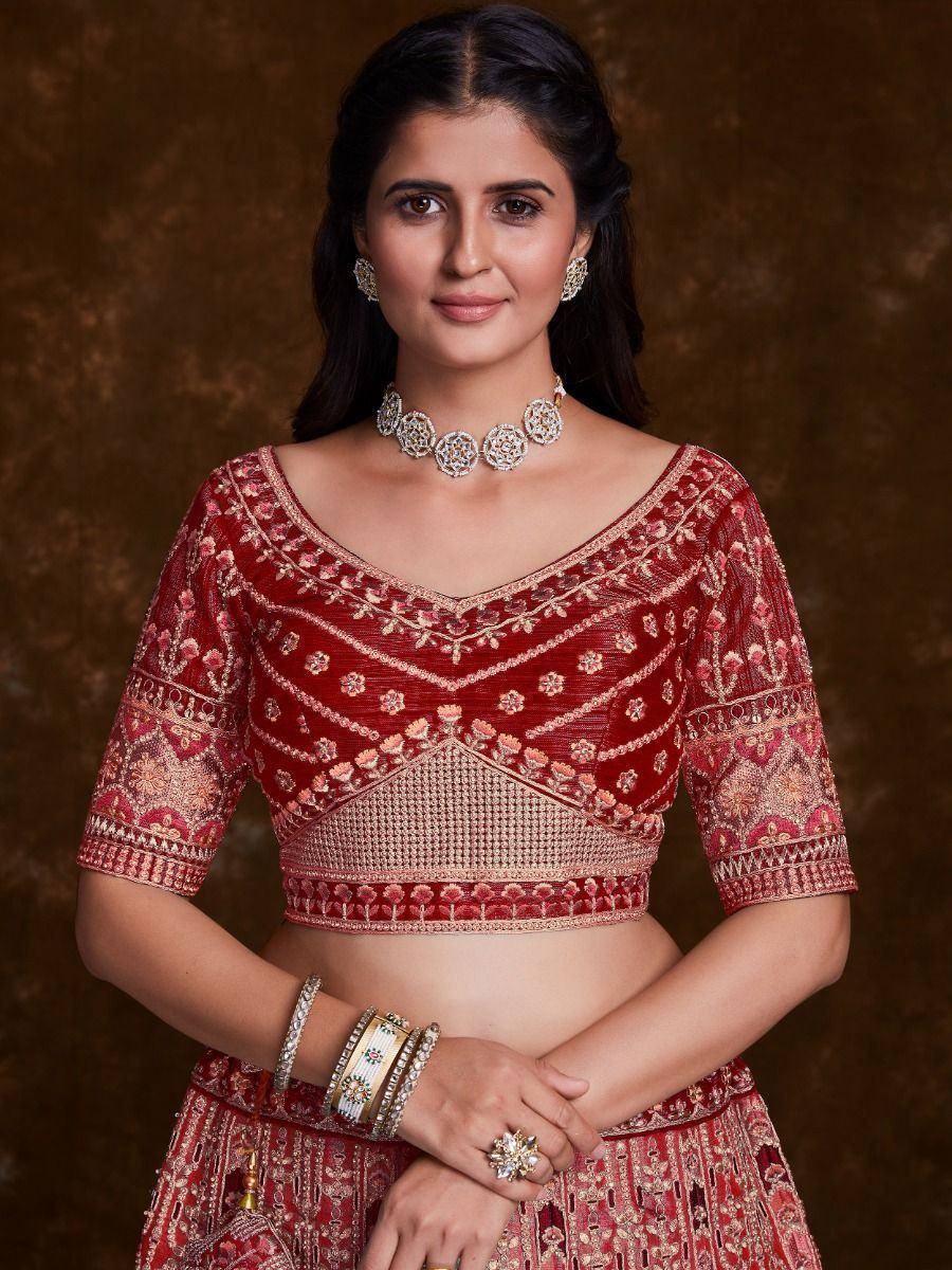 Red embroidered lehenga choli with gold detailing, perfect for Indian weddings and festive occasions