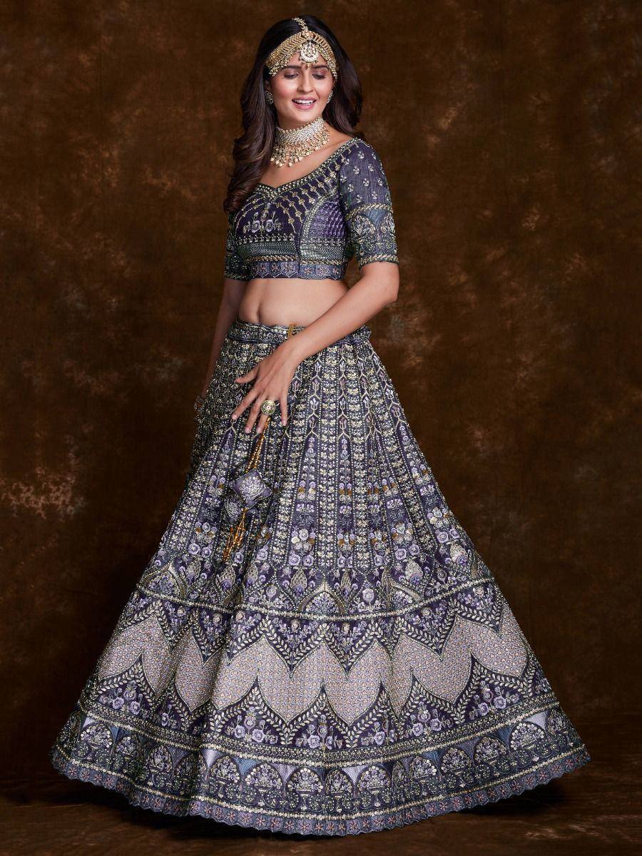 Elegant purple lehenga choli with intricate gold embroidery, perfect for Indian weddings and festive occasions