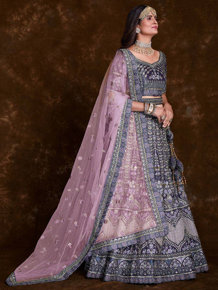 Elegant purple and blue embroidered lehenga choli with sheer dupatta, perfect for Indian weddings and festive occasions.