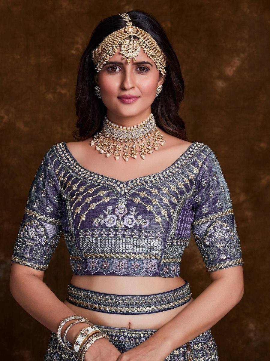 Purple embroidered lehenga choli with gold jewelry, perfect for Indian ethnic wear occasions