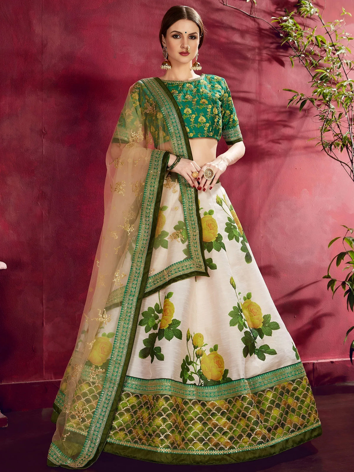 Woman wearing a green embroidered blouse and white floral print lehenga choli with dupatta