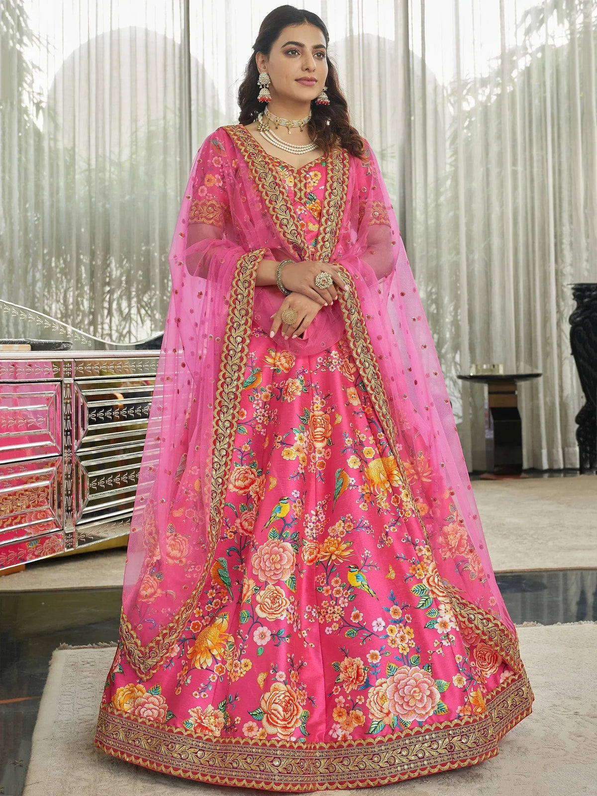 Pink floral embroidered lehenga choli with gold border, perfect for Indian weddings and festive occasions