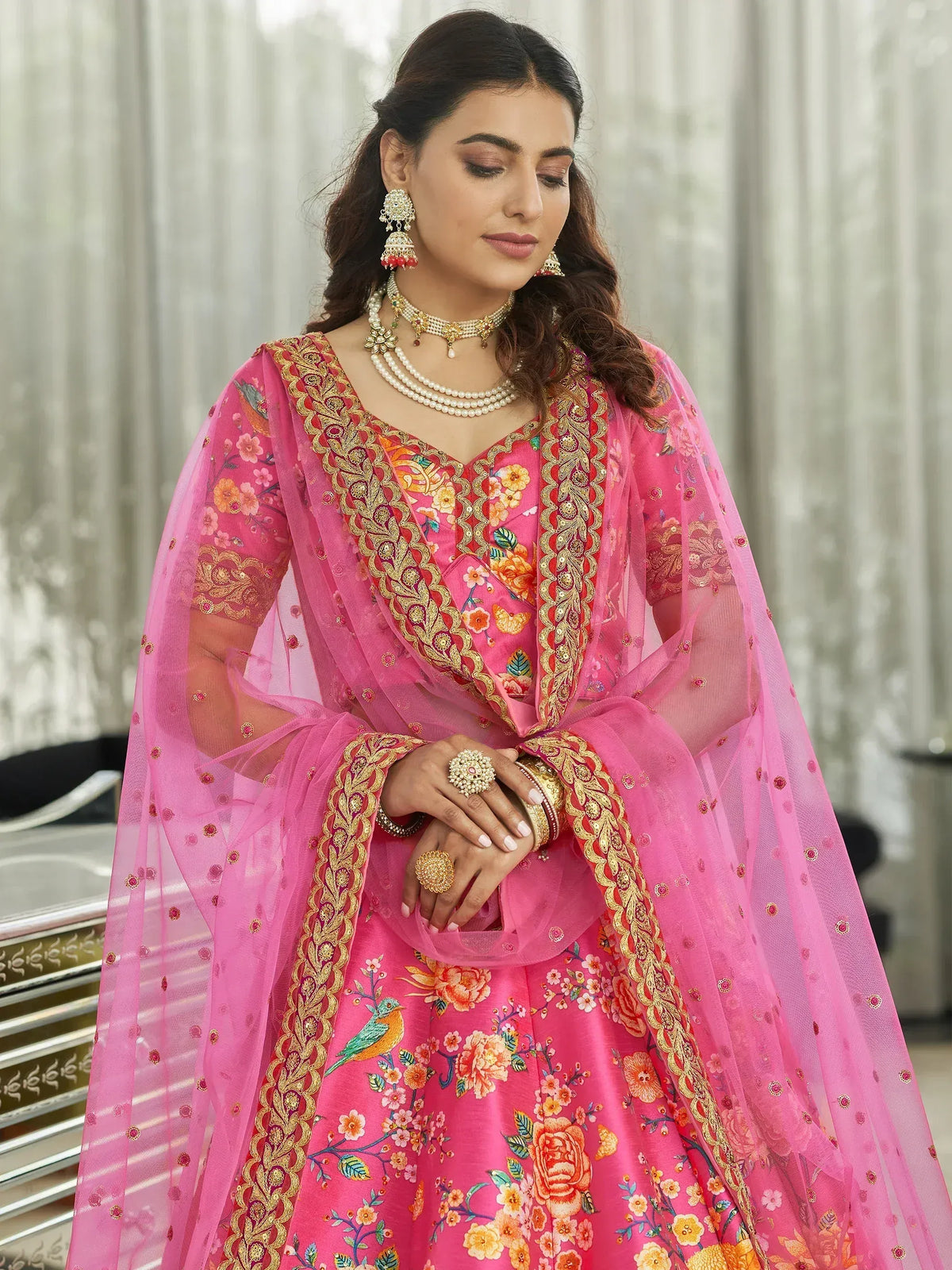 Pink floral embroidered lehenga choli with gold detailing and sheer dupatta, perfect for Indian ethnic wear