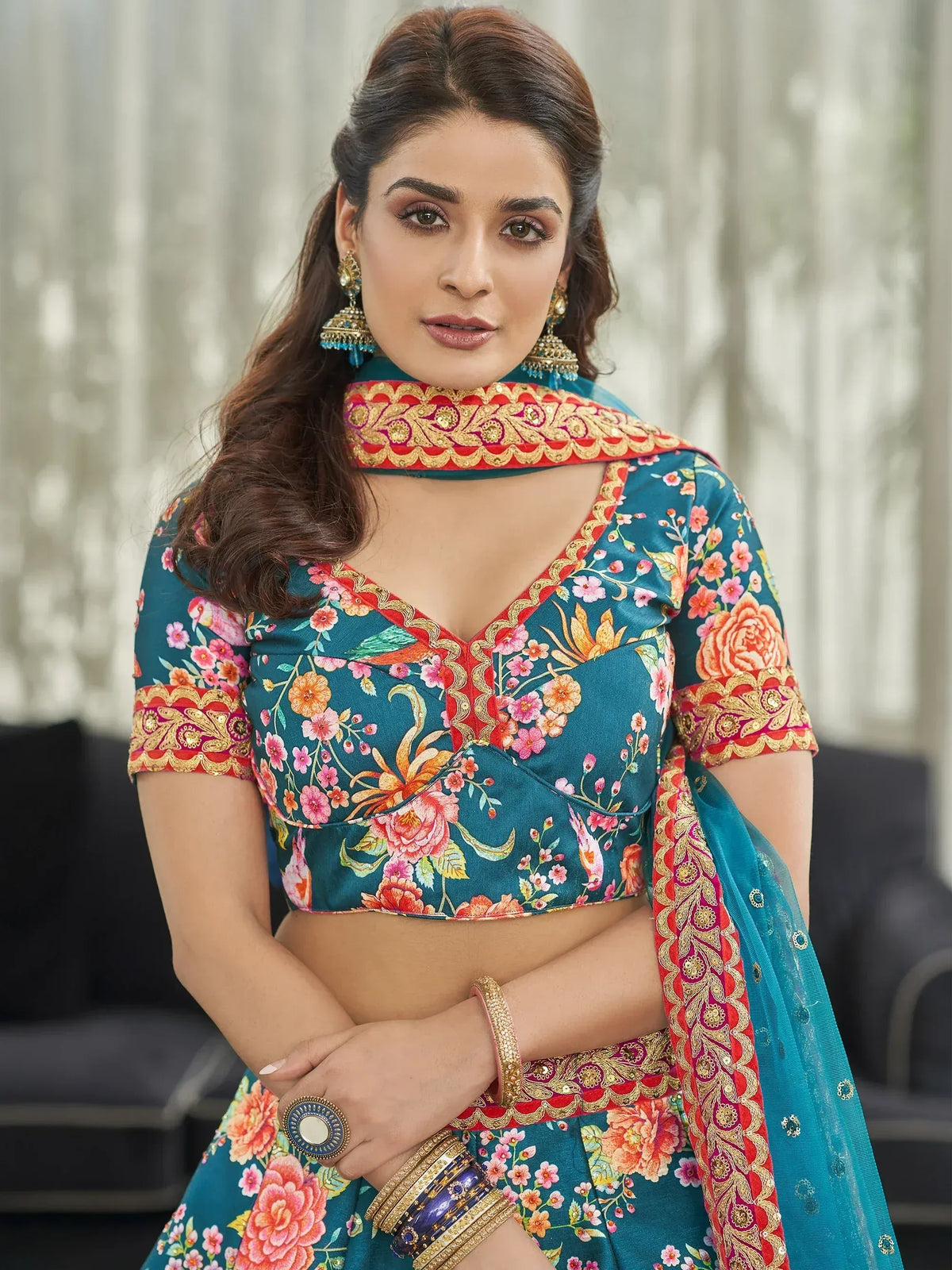Teal floral lehenga choli with gold embroidery and matching dupatta, perfect for Indian ethnic wear occasions.
