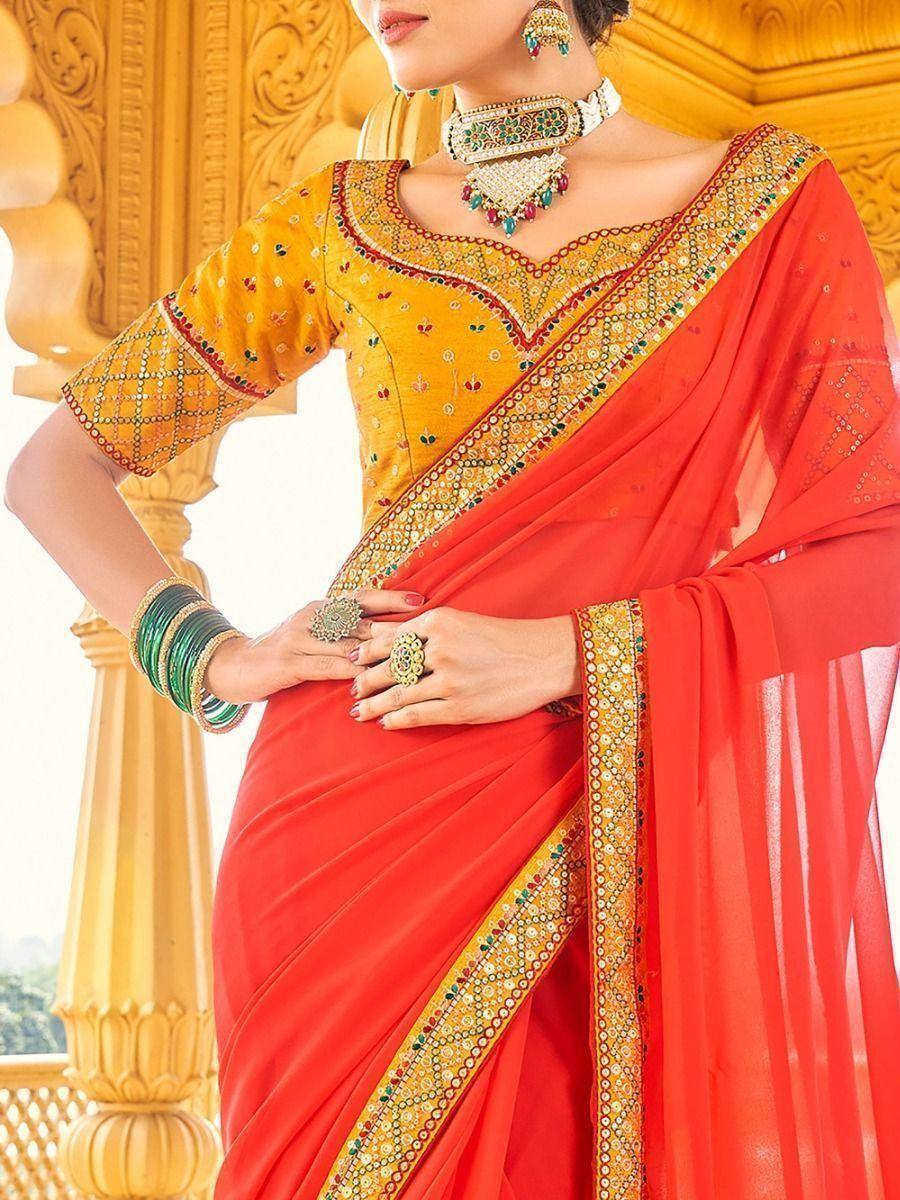 Vibrant red saree with gold embroidery and yellow blouse, styled with traditional Indian jewelry for festive occasions