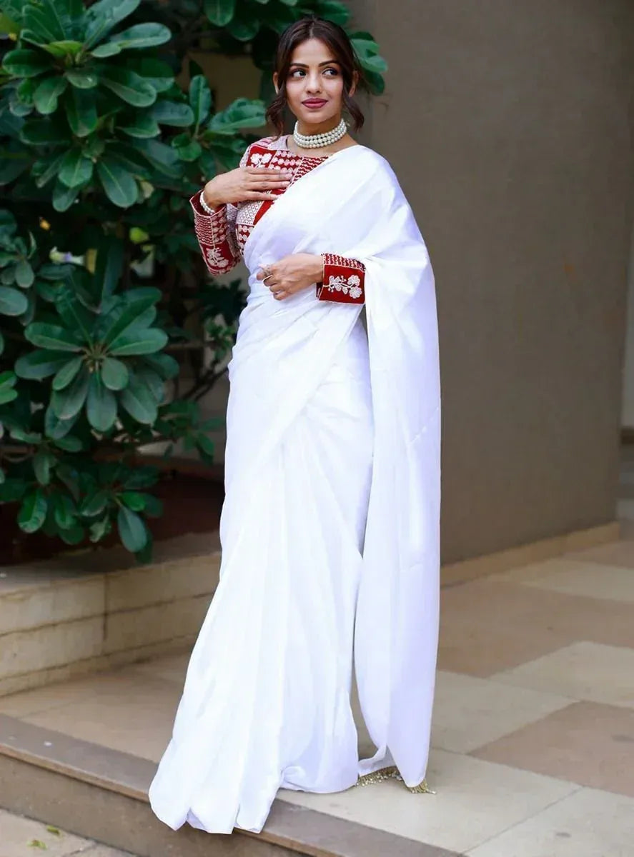 White saree with red embroidered blouse, pearl necklace, ethnic Indian wear for women