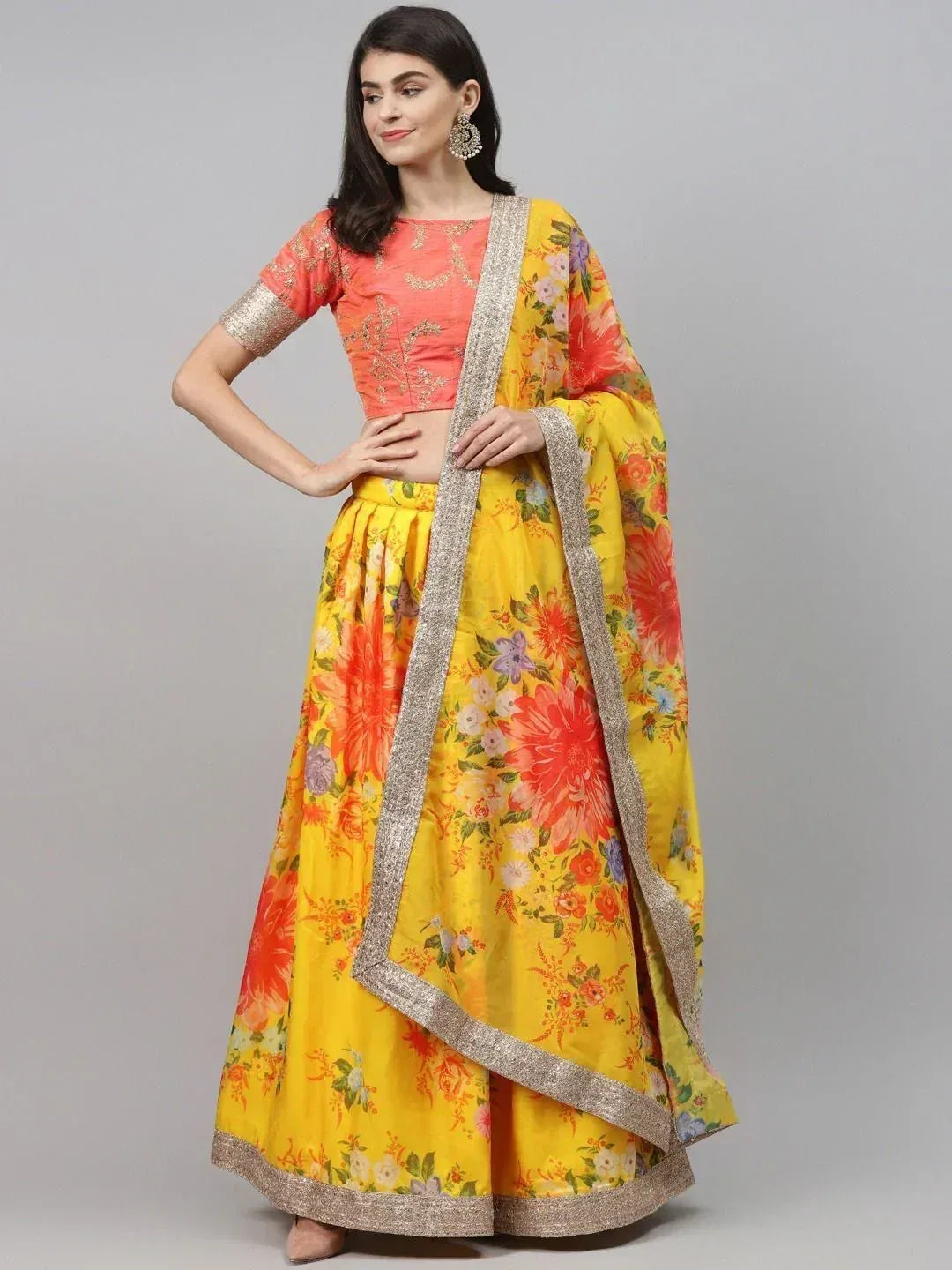 Yellow floral lehenga choli with peach blouse and gold trim, Indian ethnic wear