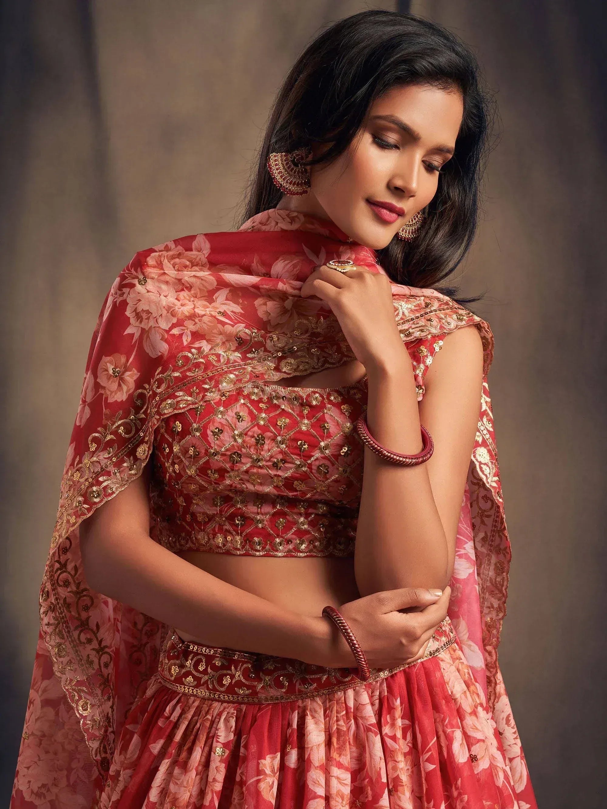 Red floral lehenga choli with gold embroidery, perfect for Indian weddings and festive occasions.
