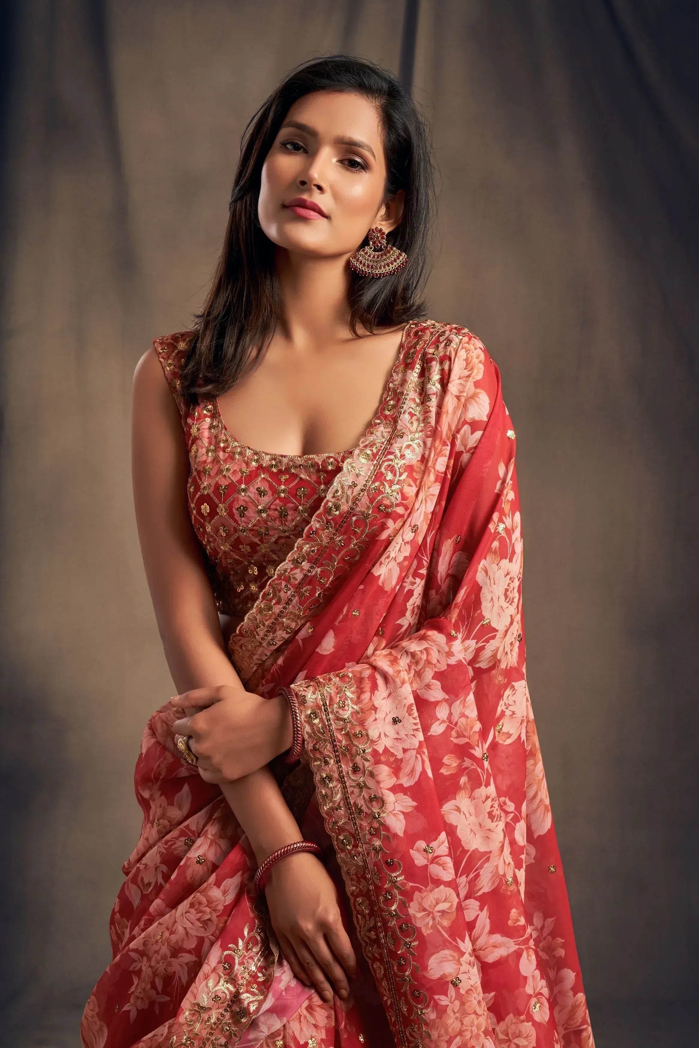 Woman in red floral saree with gold embroidery, traditional Indian ethnic wear