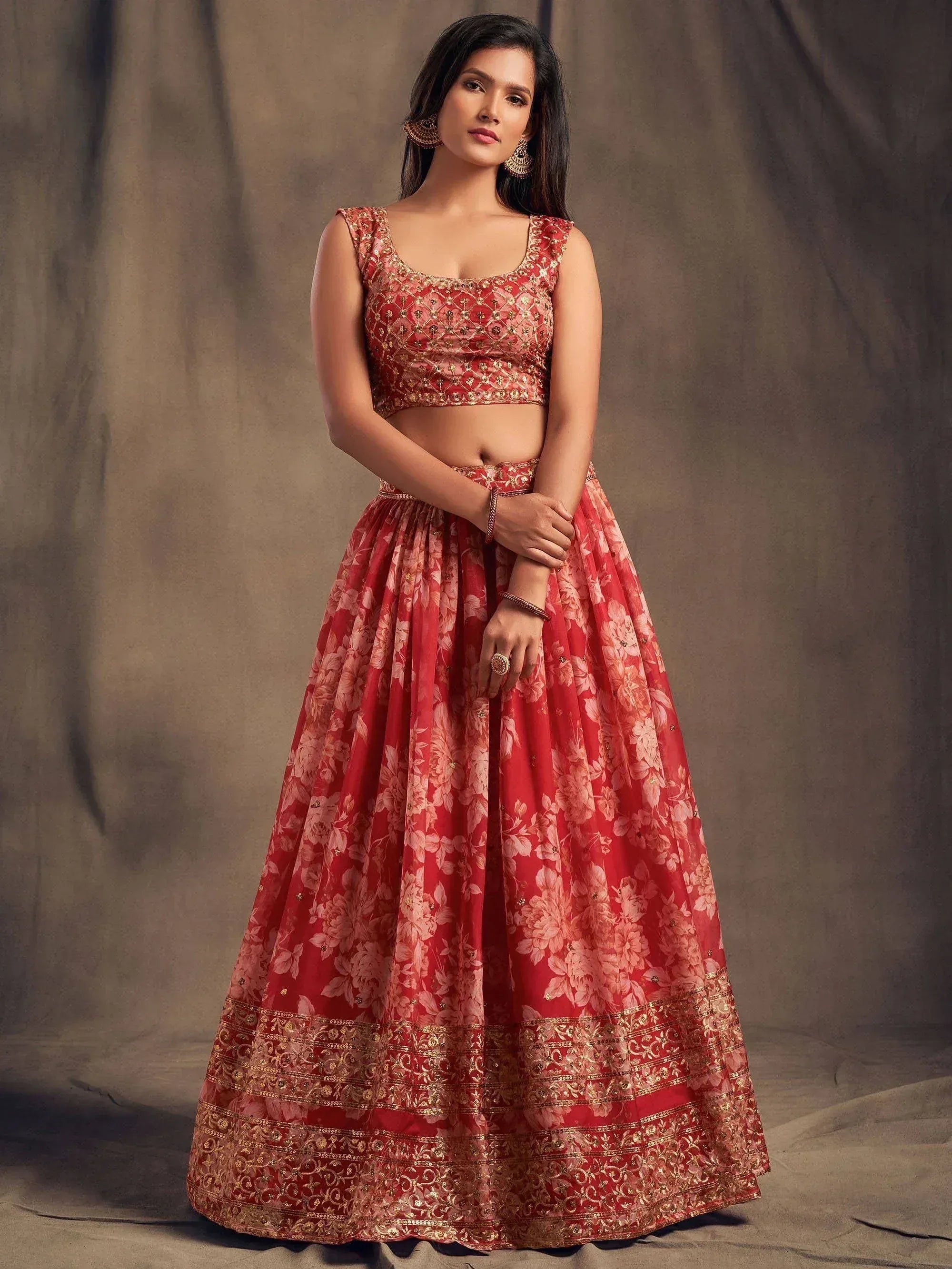 Red floral lehenga choli with gold embroidery, perfect for Indian weddings and festive occasions.