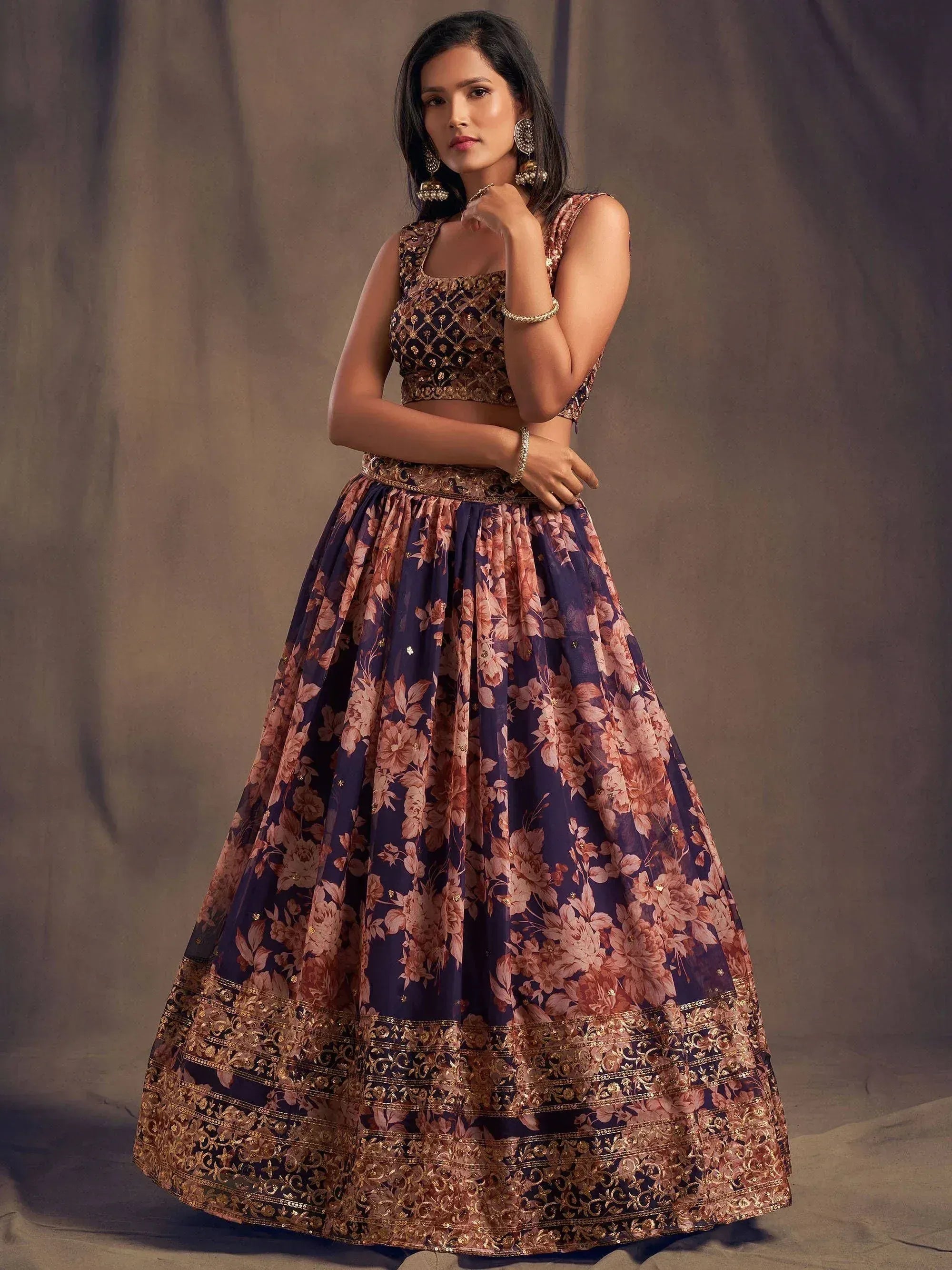 Elegant purple floral lehenga choli with gold embroidery, perfect for Indian ethnic occasions.