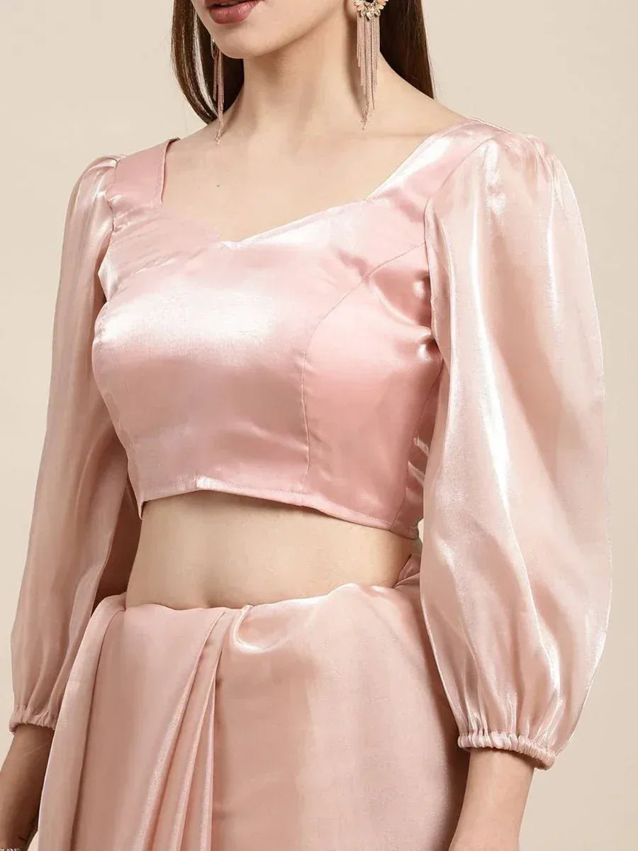 Pink satin crop top with puff sleeves, paired with matching ethnic skirt for festive wear