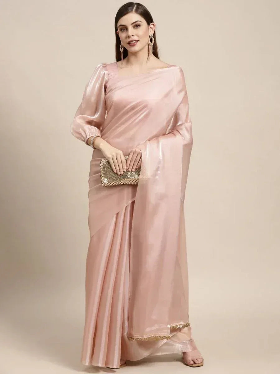 Elegant pink satin saree with puff sleeves, gold trim, and sequin clutch for Indian ethnic wear