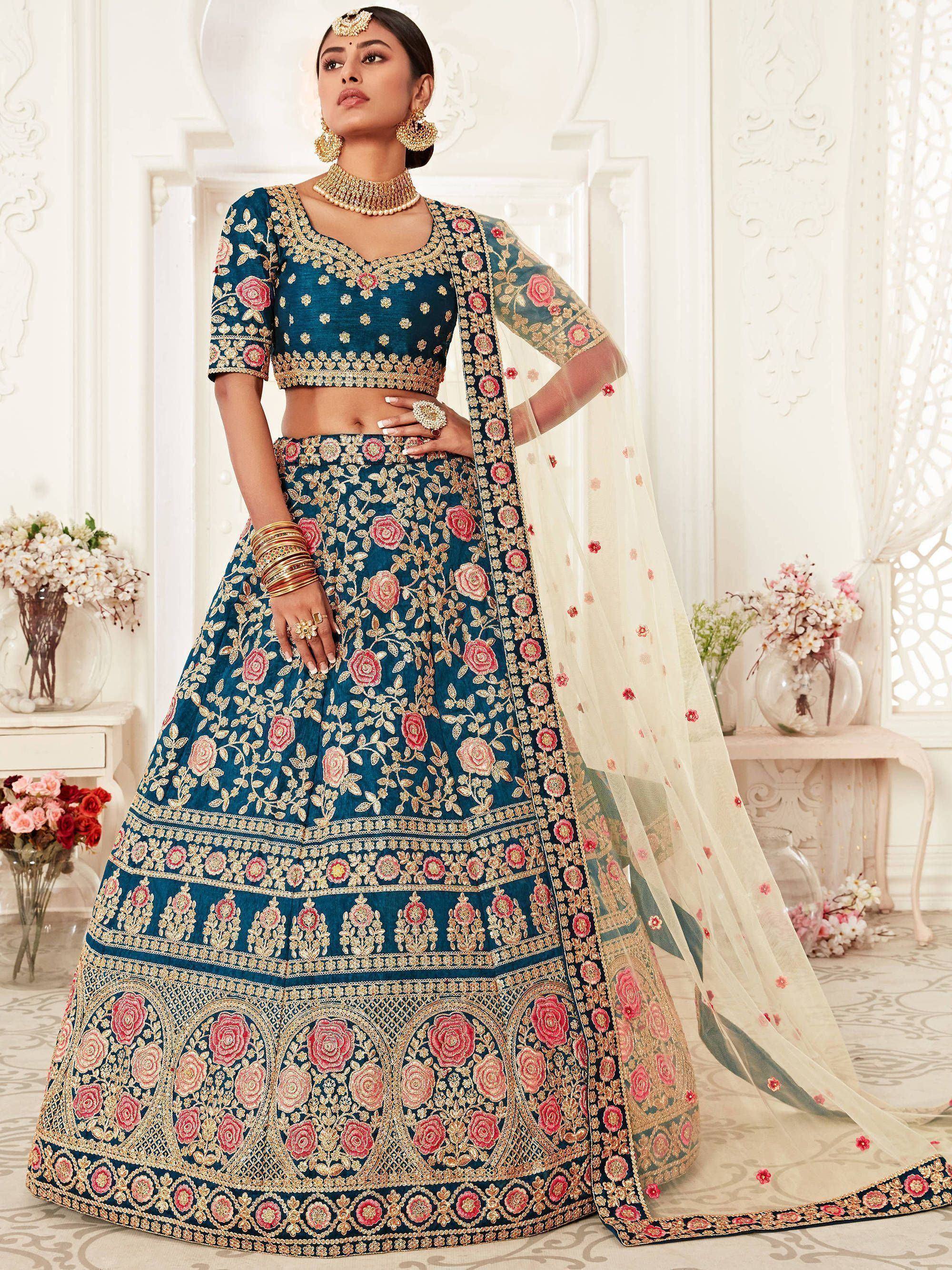 Teal blue designer lehenga choli with pink floral embroidery, gold detailing, and sheer dupatta for Indian weddings