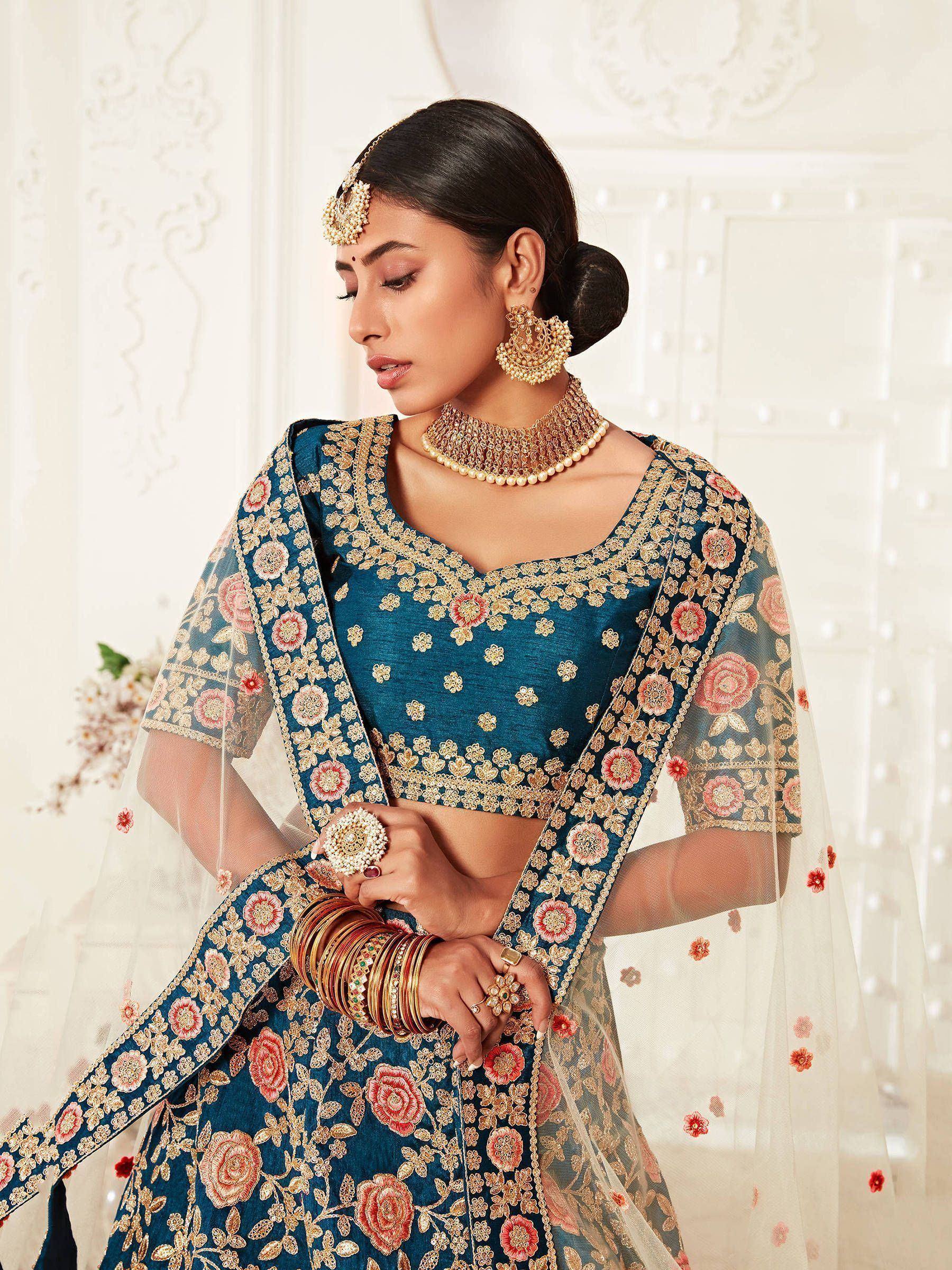 Teal floral embroidered lehenga choli with gold detailing, perfect for Indian weddings and festive occasions