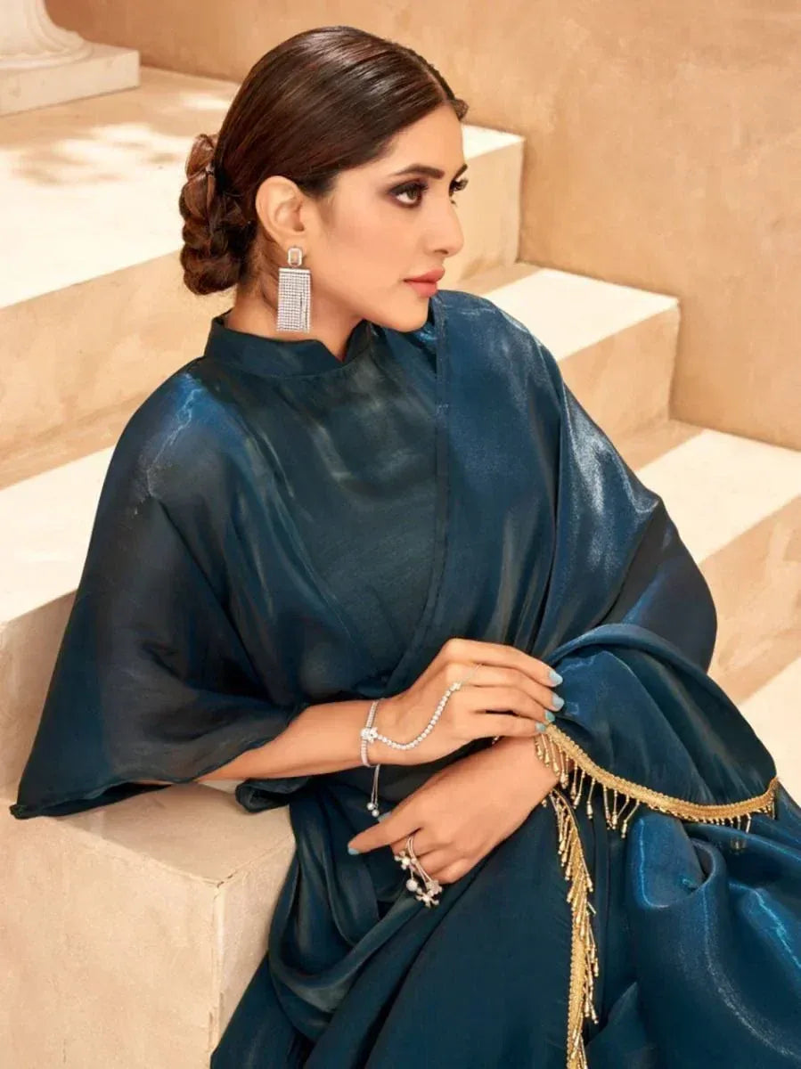 Elegant navy blue ethnic gown with gold fringe, styled with statement earrings and pearl jewelry