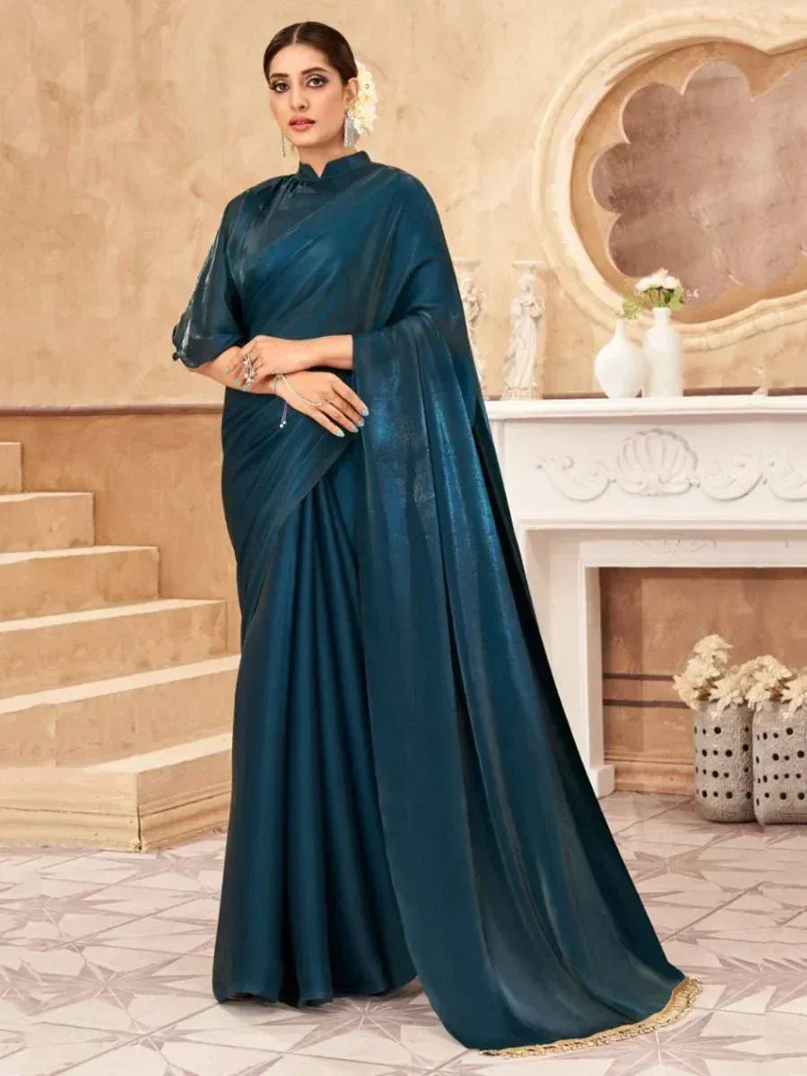 Elegant teal satin saree with gold trim, styled for Indian ethnic occasions